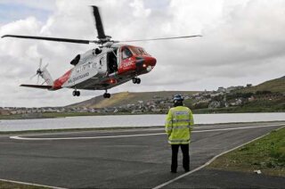 The coastguard helicopter lands at the current site at Clickimin.