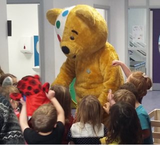 Primary one pupils crowd around their special visitor