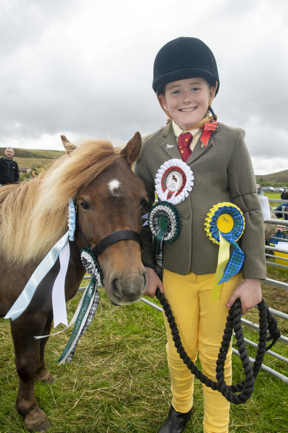 A delighted Annie Wilson (9) with her pony Filska Cossack, participation class winner, lead rein, young handler and reserve performance champion.