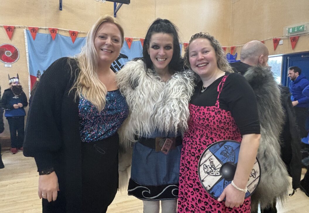Wendy Hatrick (in the middle) at South Nesting Primary School with teacher Laura Tulloch and head-teacher Sandra Petrie. Photo: Chloe Irvine